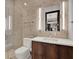 Modern bathroom featuring a glass-enclosed shower, floating vanity, and neutral-toned tile at 8521 Lake Nona Shore Dr, Orlando, FL 32827