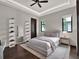 Contemporary bedroom with a neutral color scheme, unique shelving, and hardwood floors at 8521 Lake Nona Shore Dr, Orlando, FL 32827