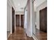 Hallway features dark wood floors, modern sliding doors, and decorative mirror at 8521 Lake Nona Shore Dr, Orlando, FL 32827