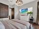 Relaxing main bedroom with modern fixtures, a dresser, and a TV on the wall at 8521 Lake Nona Shore Dr, Orlando, FL 32827