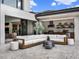 Beautiful outdoor living space with a stylish sectional sofa, summer kitchen, and seamless indoor-outdoor flow at 8521 Lake Nona Shore Dr, Orlando, FL 32827