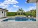 Gorgeous pool area with a relaxing spa, sun loungers, manicured lawn, and lush landscaping for serene outdoor living at 8521 Lake Nona Shore Dr, Orlando, FL 32827