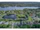 Beautiful aerial view of lakeside homes featuring lush greenery and a tranquil lake at 876 Kensington Gardens Ct, Oviedo, FL 32765