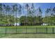 Lush backyard features a black metal fence, offering privacy and serene views of the surrounding water and trees at 876 Kensington Gardens Ct, Oviedo, FL 32765