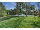 Lush green backyard featuring both wrought iron and white fencing, offering ample space for outdoor activities at 876 Kensington Gardens Ct, Oviedo, FL 32765