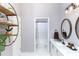 Neutral bathroom featuring a double vanity, decorative shelving and a peek at the tub and shower at 876 Kensington Gardens Ct, Oviedo, FL 32765