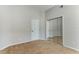 This is a well-lit, empty bedroom with tan carpet and mirrored closet doors, ready to be furnished at 876 Kensington Gardens Ct, Oviedo, FL 32765