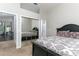 This bedroom features neutral walls, mirrored closet doors, and a doorway leading to the rest of the house at 876 Kensington Gardens Ct, Oviedo, FL 32765