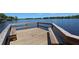 Wooden dock with built-in benches overlooking a tranquil lake at 876 Kensington Gardens Ct, Oviedo, FL 32765