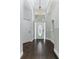 Welcoming foyer with wood floors, transom window, and chandelier at 876 Kensington Gardens Ct, Oviedo, FL 32765