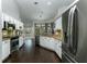 Modern kitchen featuring stainless steel appliances, white cabinetry, and hardwood floors at 876 Kensington Gardens Ct, Oviedo, FL 32765