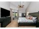 Well-lit main bedroom with ceiling fan, dresser, and access to a private patio with picturesque outdoor views at 876 Kensington Gardens Ct, Oviedo, FL 32765