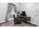 Home office area with a dark wooden desk and chair, plus a window with beige curtains for natural light at 876 Kensington Gardens Ct, Oviedo, FL 32765