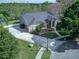 Aerial view of house with a long driveway, beautiful landscaping, and a well maintained lawn at 876 Kensington Gardens Ct, Oviedo, FL 32765