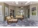 Covered patio with stone flooring and wicker furniture at 876 Kensington Gardens Ct, Oviedo, FL 32765