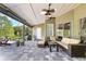 Inviting covered patio with ceiling fans and comfortable wicker furniture, perfect for outdoor relaxation and entertaining at 876 Kensington Gardens Ct, Oviedo, FL 32765