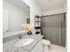 Bathroom featuring granite sink, modern shelf, and a shower with a gray curtain at 965 Lido Dr, Howey In The Hills, FL 34737