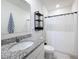 Bathroom features a white granite sink, a shower with a curtain, and a modern wall shelf at 965 Lido Dr, Howey In The Hills, FL 34737