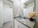 Bathroom featuring a granite countertop, decorative accents, and a bright, white color scheme at 965 Lido Dr, Howey In The Hills, FL 34737