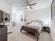 Bedroom boasts a ceiling fan, a bed, and guitars, providing a comfortable space with a desk area at 965 Lido Dr, Howey In The Hills, FL 34737