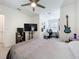 View of a bedroom with ceiling fan, TV, and guitars hanging on the wall near the office area at 965 Lido Dr, Howey In The Hills, FL 34737