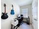 Comfortable bedroom featuring a desk, computer, and decorated with guitars for an office-like space at 965 Lido Dr, Howey In The Hills, FL 34737