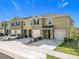 Modern townhome with attached garages and manicured front yards creating curb appeal at 965 Lido Dr, Howey In The Hills, FL 34737