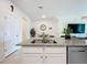 Kitchen island with granite countertop and undermount sink at 965 Lido Dr, Howey In The Hills, FL 34737