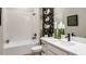 Bathroom with a bathtub, white vanity, modern fixtures, and decor accents at 985 Tassleflower Trl, St Cloud, FL 34771