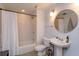 Bathroom featuring tiled shower/tub, classic sink and round mirror at 10 N Summerlin Ave # 55, Orlando, FL 32801