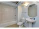 Bathroom featuring white subway tiles, a standard bathtub and a sleek pedestal sink at 10 N Summerlin Ave # 55, Orlando, FL 32801