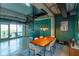 Open dining space adjacent to a spiral staircase, enhancing the loft's industrial aesthetic with vibrant teal walls at 10 N Summerlin Ave # 55, Orlando, FL 32801