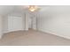 Carpeted bedroom featuring a ceiling fan, closet and an open doorway at 1019 Spring Landing Dr, Winter Garden, FL 34787