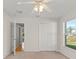 Carpeted bedroom featuring a ceiling fan, closet and backyard views at 1019 Spring Landing Dr, Winter Garden, FL 34787