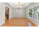 Dining room with hardwood floors, elegant chandelier, and a view of the front yard at 1019 Spring Landing Dr, Winter Garden, FL 34787