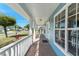 Covered front porch with brick flooring and white columns, offering a welcoming outdoor space at 1019 Spring Landing Dr, Winter Garden, FL 34787