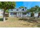 Inviting blue home featuring dormer windows, a covered front porch, and mature landscaping at 1019 Spring Landing Dr, Winter Garden, FL 34787