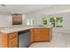 Kitchen sink with cabinetry and dishwasher, adjoining fireplace and bright windows at 1019 Spring Landing Dr, Winter Garden, FL 34787