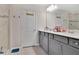 Bathroom features double sinks, gray vanity, and glass enclosed shower at 11038 Leafshore Loop, Orlando, FL 32829