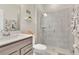 Modern bathroom showcases a glass-enclosed shower and neutral color palette at 11038 Leafshore Loop, Orlando, FL 32829