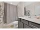 Bathroom with gray vanity, white countertops, and shower/tub with gray curtain at 11038 Leafshore Loop, Orlando, FL 32829