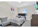 Bedroom featuring a comfortable bed, artwork, and a large window at 11038 Leafshore Loop, Orlando, FL 32829