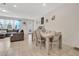 Open-concept dining area with table and chairs adjacent to the living room, bathed in natural light at 11038 Leafshore Loop, Orlando, FL 32829