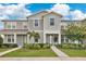Charming townhome with well-maintained landscaping, complemented by blue skies and curb appeal at 11038 Leafshore Loop, Orlando, FL 32829