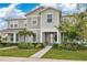 Inviting two-story townhome with a quaint front porch and lush, green landscaping at 11038 Leafshore Loop, Orlando, FL 32829