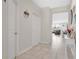 Neutral hallway with tile flooring that leads to an open concept living area at 11038 Leafshore Loop, Orlando, FL 32829