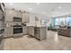 Bright kitchen with stainless steel appliances and ample counter space open to the living area at 11038 Leafshore Loop, Orlando, FL 32829