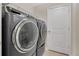 Laundry room with large front loading washer and dryer at 11038 Leafshore Loop, Orlando, FL 32829