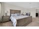 Comfortable main bedroom features a rustic wood bed frame and neutral decor at 11038 Leafshore Loop, Orlando, FL 32829