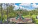 View of a community playground featuring slides, a climbing structure, and a safety fence at 11038 Leafshore Loop, Orlando, FL 32829